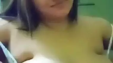 Cute girl opens bra to show sexy boobs to lover