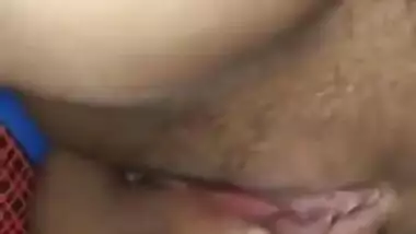 Indian woman touches her pink vagina with two hands in close-up porn